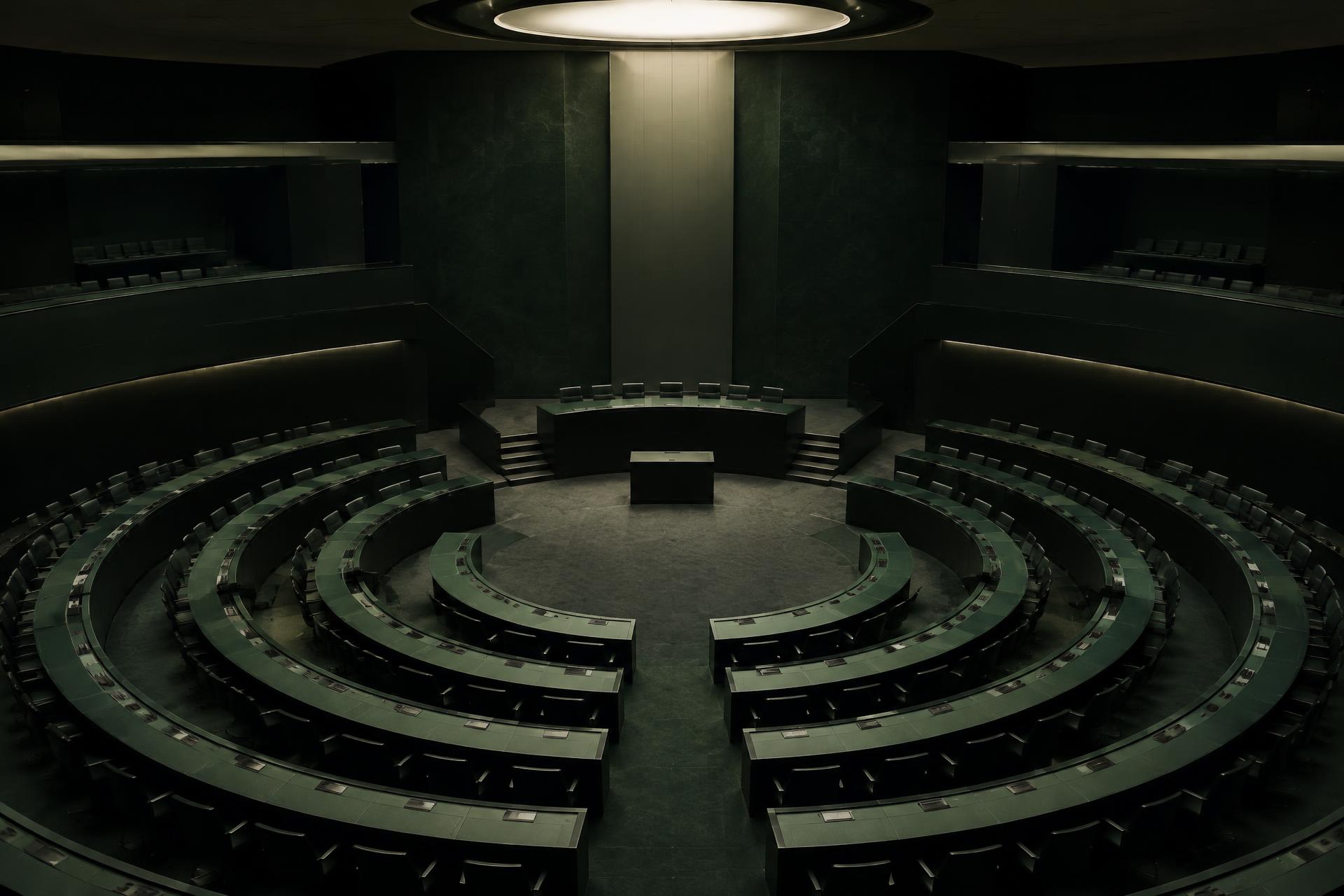 Empty circular assembly chamber with concentric rows of delegate desks